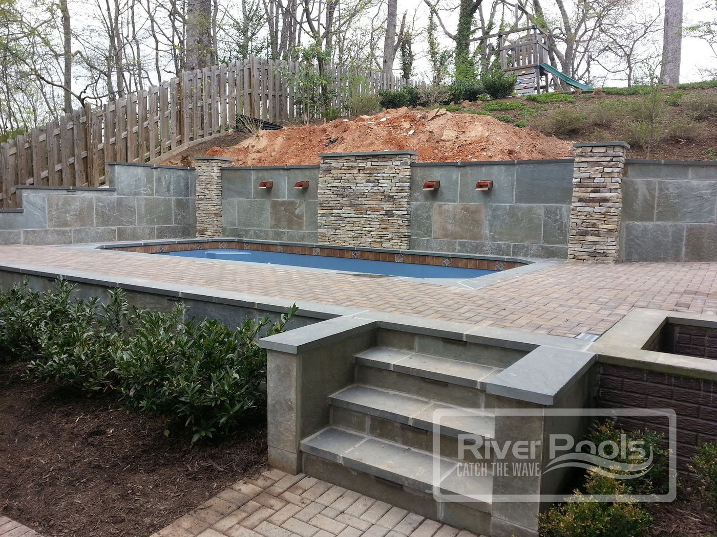 fiberglass pool with retaining wall